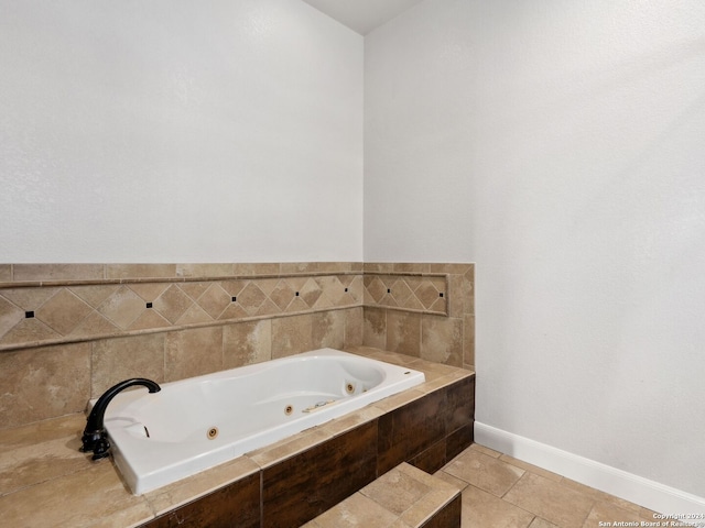 bathroom featuring tiled bath and tile patterned flooring