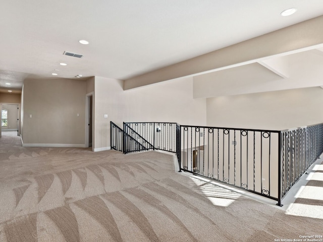 hallway featuring light carpet