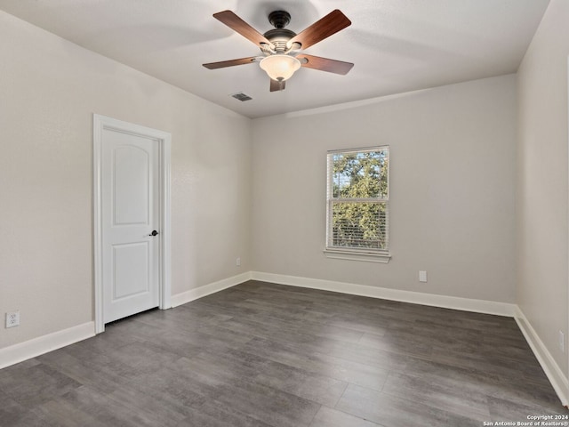 unfurnished room featuring ceiling fan and dark wood-type flooring