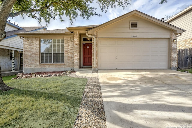 ranch-style home with a garage and a front lawn