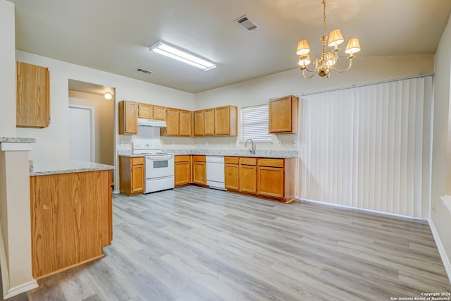 kitchen featuring white appliances, sink, decorative light fixtures, light hardwood / wood-style flooring, and an inviting chandelier