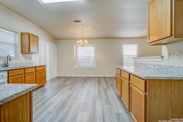 kitchen with a wealth of natural light, sink, an inviting chandelier, and light wood-type flooring