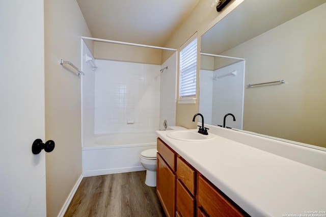 full bathroom with hardwood / wood-style floors, vanity, toilet, and tiled shower / bath combo