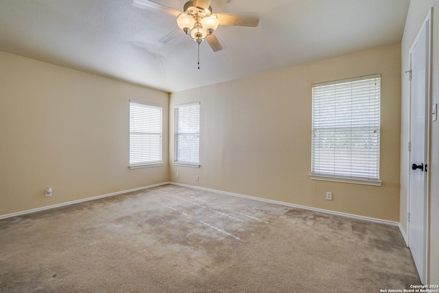 carpeted spare room featuring ceiling fan