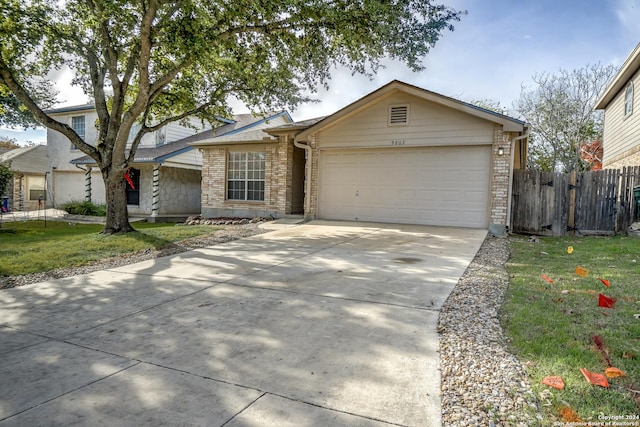 ranch-style house featuring a garage and a front yard