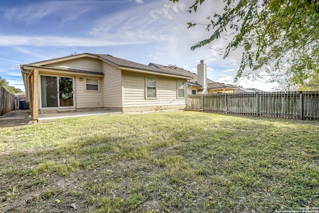 back of house featuring a yard, a patio, and central air condition unit