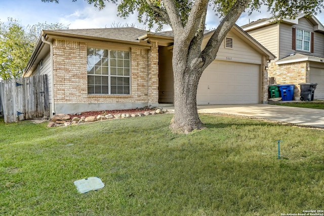 view of front of house featuring a garage and a front lawn