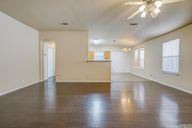 unfurnished living room with dark hardwood / wood-style flooring and ceiling fan with notable chandelier