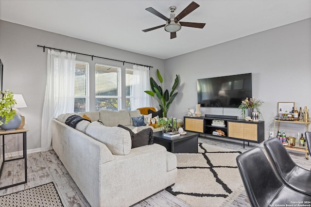 living room with ceiling fan and light wood-type flooring