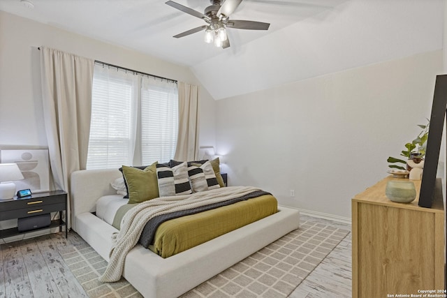 bedroom featuring lofted ceiling, ceiling fan, and wood-type flooring