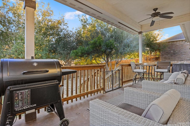 deck with outdoor lounge area, ceiling fan, a bar, and a grill