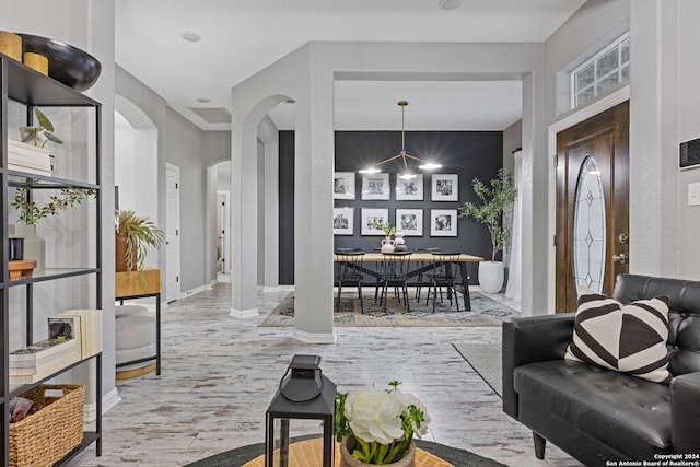 living room featuring a notable chandelier