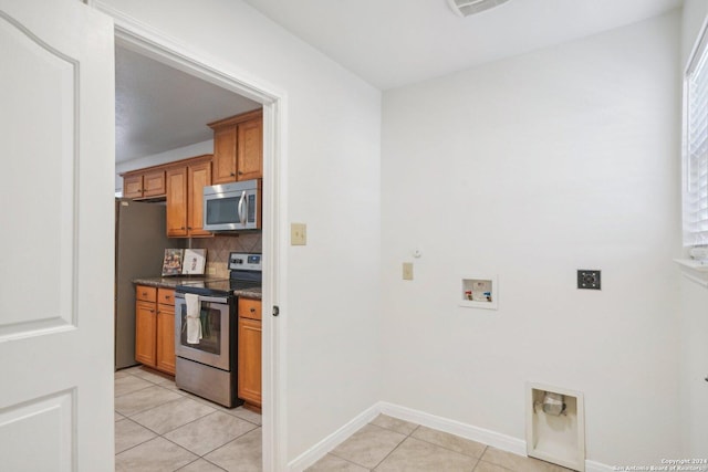 kitchen with light tile patterned floors and appliances with stainless steel finishes