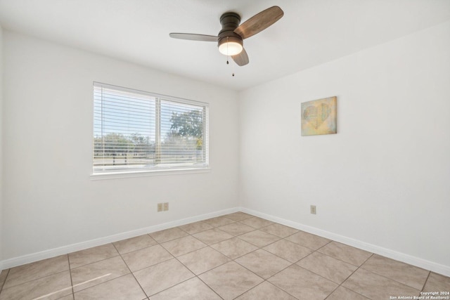 unfurnished room with ceiling fan and light tile patterned flooring