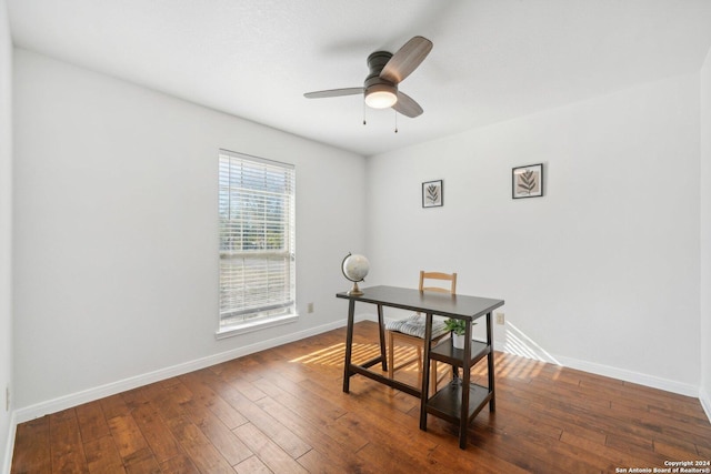 home office with ceiling fan and dark hardwood / wood-style flooring