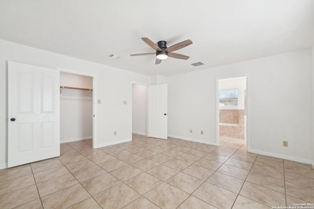 unfurnished bedroom with light tile patterned floors, a closet, and ceiling fan