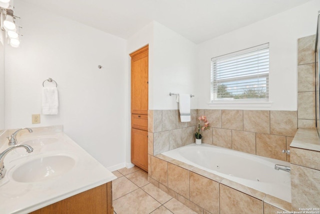 bathroom with tile patterned floors, vanity, and a relaxing tiled tub