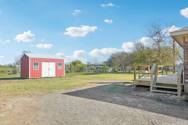 view of yard with a shed, a trampoline, and a deck