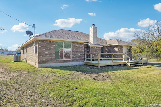 back of property with a lawn, cooling unit, and a deck