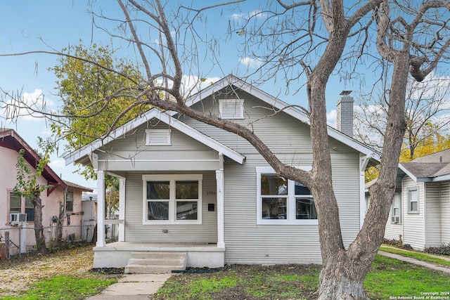 bungalow-style home with cooling unit and a porch