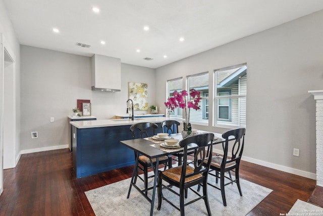 dining space with dark hardwood / wood-style flooring and sink