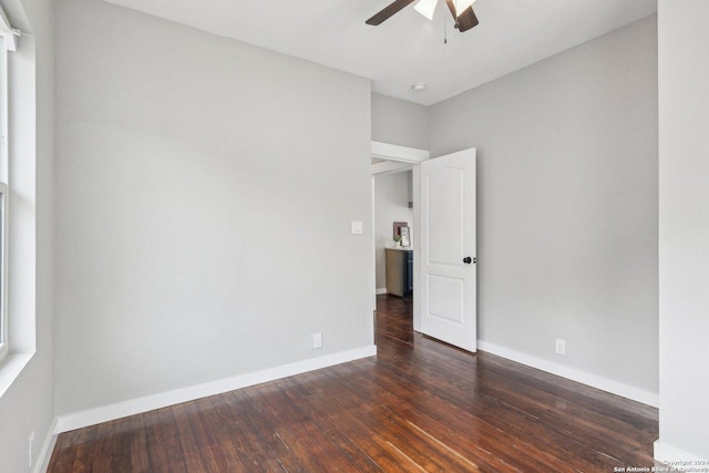 unfurnished room featuring ceiling fan and dark hardwood / wood-style flooring