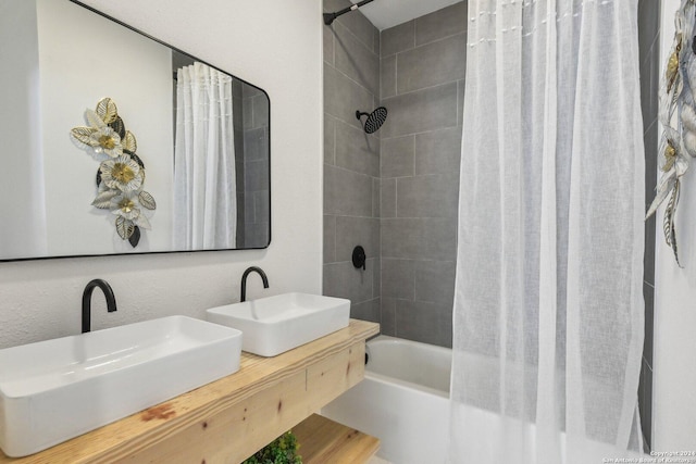 bathroom featuring vanity and shower / tub combo with curtain