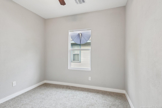 carpeted spare room with ceiling fan