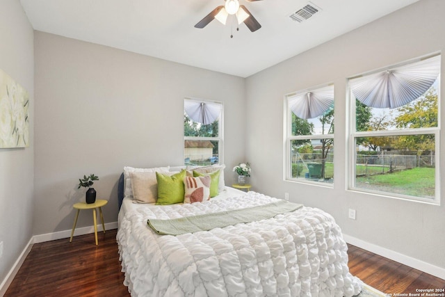 bedroom with ceiling fan and dark wood-type flooring