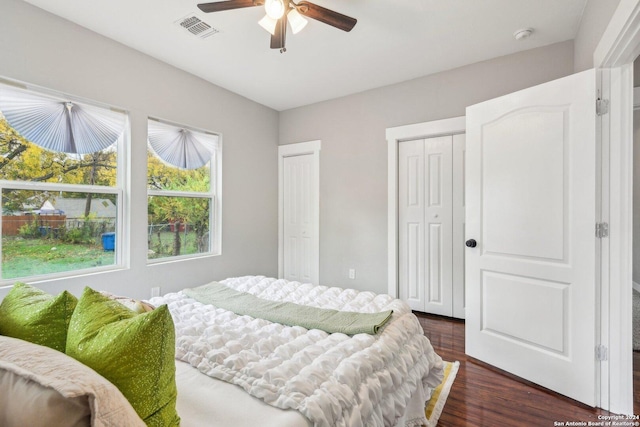 bedroom with dark hardwood / wood-style flooring and ceiling fan