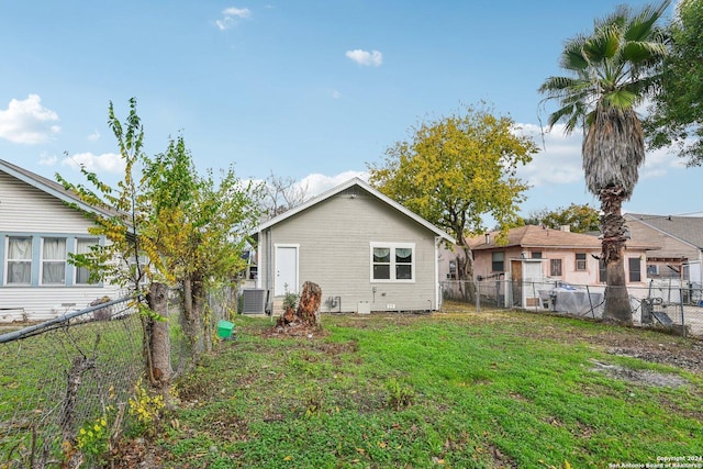 rear view of property with central AC