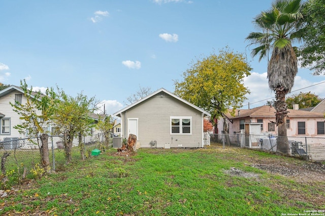 rear view of property with a lawn