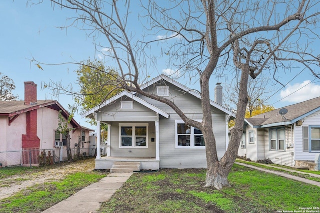 bungalow with a front lawn and a porch