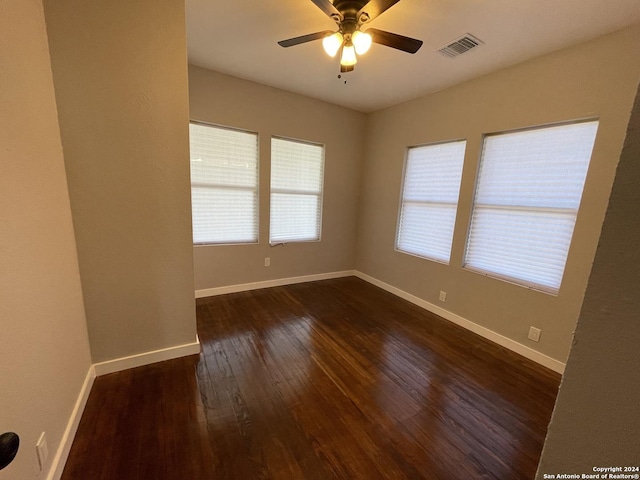 unfurnished room with ceiling fan and dark hardwood / wood-style floors