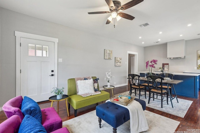 living room with ceiling fan and dark wood-type flooring