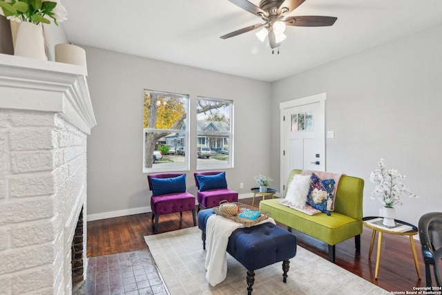 sitting room featuring wood-type flooring and ceiling fan