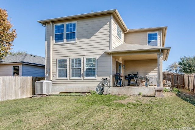 back of house with a yard, central AC unit, and a patio area