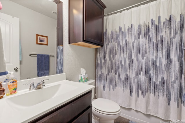 full bathroom featuring shower / bath combo with shower curtain, vanity, and toilet