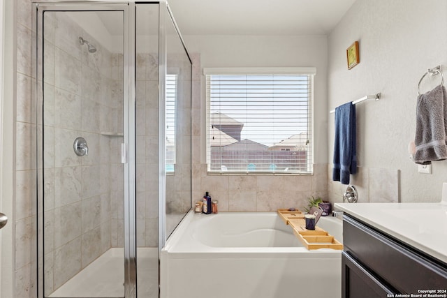 bathroom featuring vanity and separate shower and tub