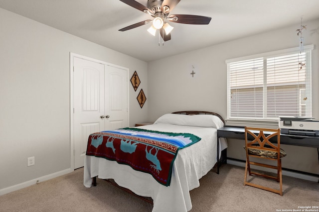 carpeted bedroom with ceiling fan, a closet, and a baseboard radiator