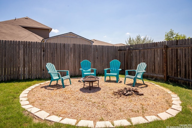 view of yard with a fire pit