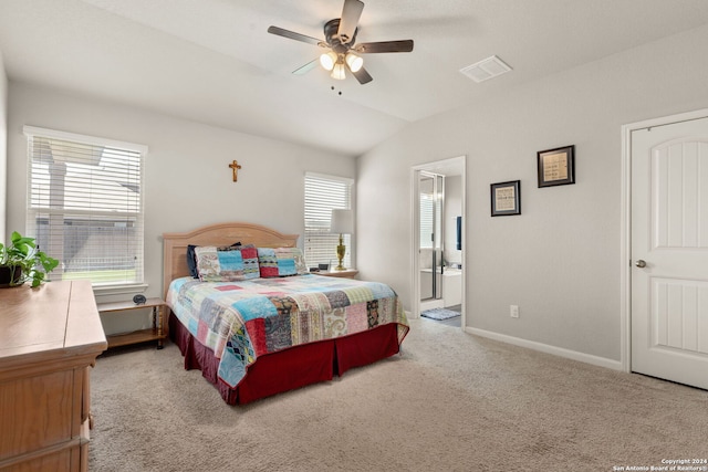 bedroom featuring ensuite bath, light carpet, ceiling fan, and lofted ceiling