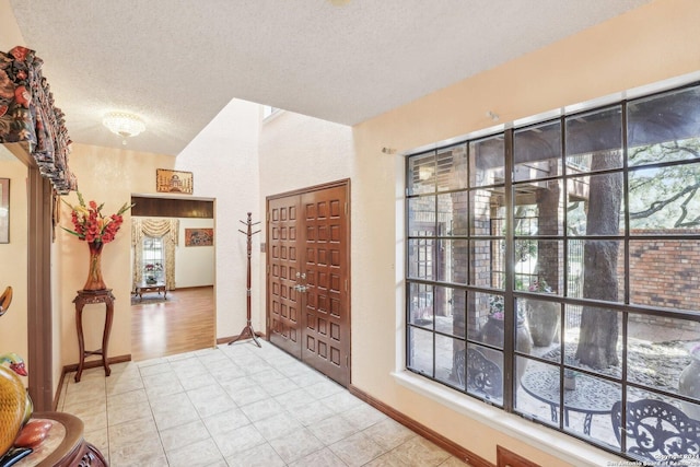 tiled foyer featuring a textured ceiling