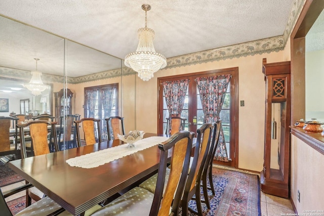 dining area with french doors, a textured ceiling, a notable chandelier, and light tile patterned flooring