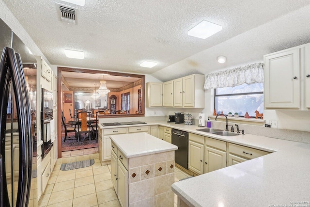 kitchen with kitchen peninsula, a textured ceiling, sink, black appliances, and pendant lighting