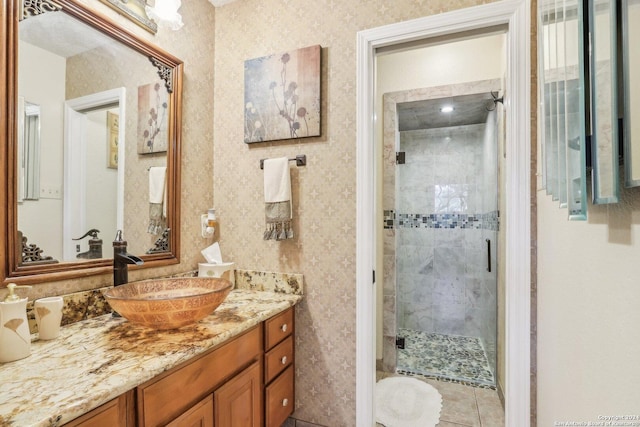 bathroom with tile patterned flooring, vanity, and a shower with door