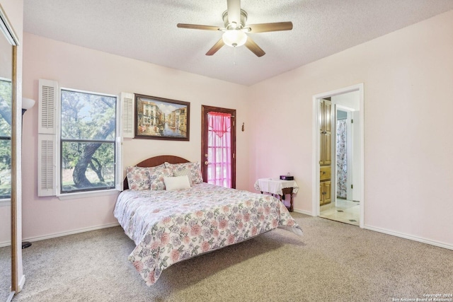 carpeted bedroom with ceiling fan, ensuite bathroom, and a textured ceiling