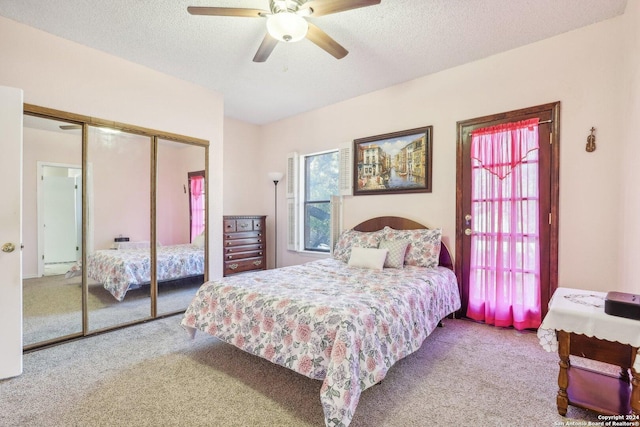 carpeted bedroom featuring a textured ceiling, a closet, multiple windows, and ceiling fan