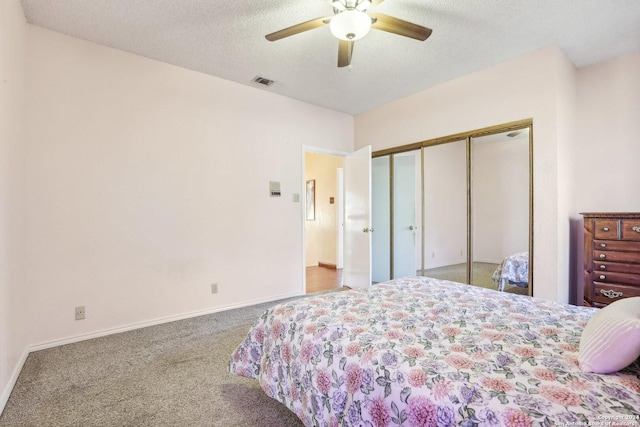 bedroom with carpet, ceiling fan, a textured ceiling, and a closet