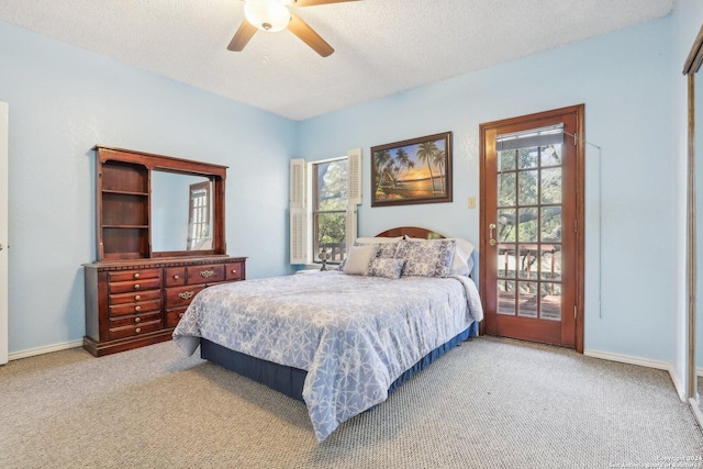 bedroom featuring ceiling fan, light colored carpet, and a textured ceiling